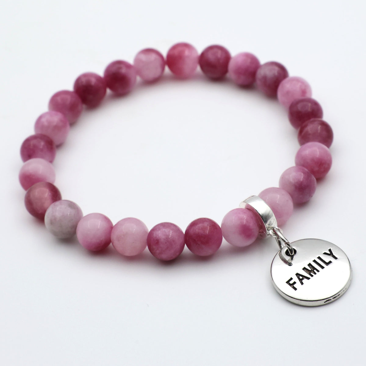 Pink beaded bracelet with a 'FAMILY' charm on a white background