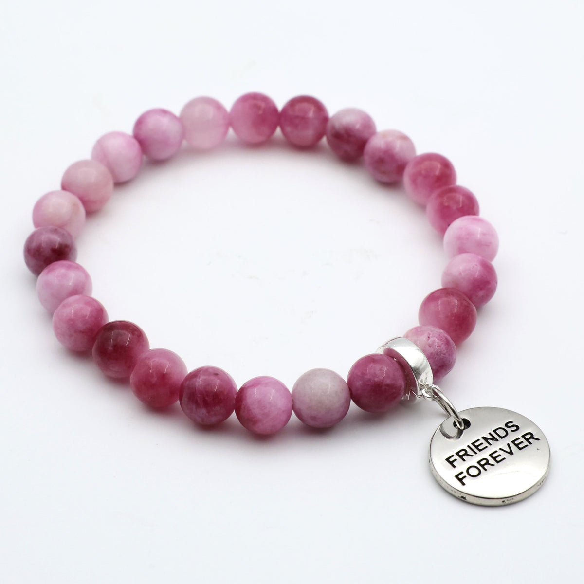 Pink beaded bracelet with a 'Friends Forever' charm on a white background