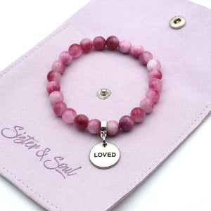 Pink beaded bracelet with 'LOVED' charm on a pink card with 'Sister & Soul' branding.
