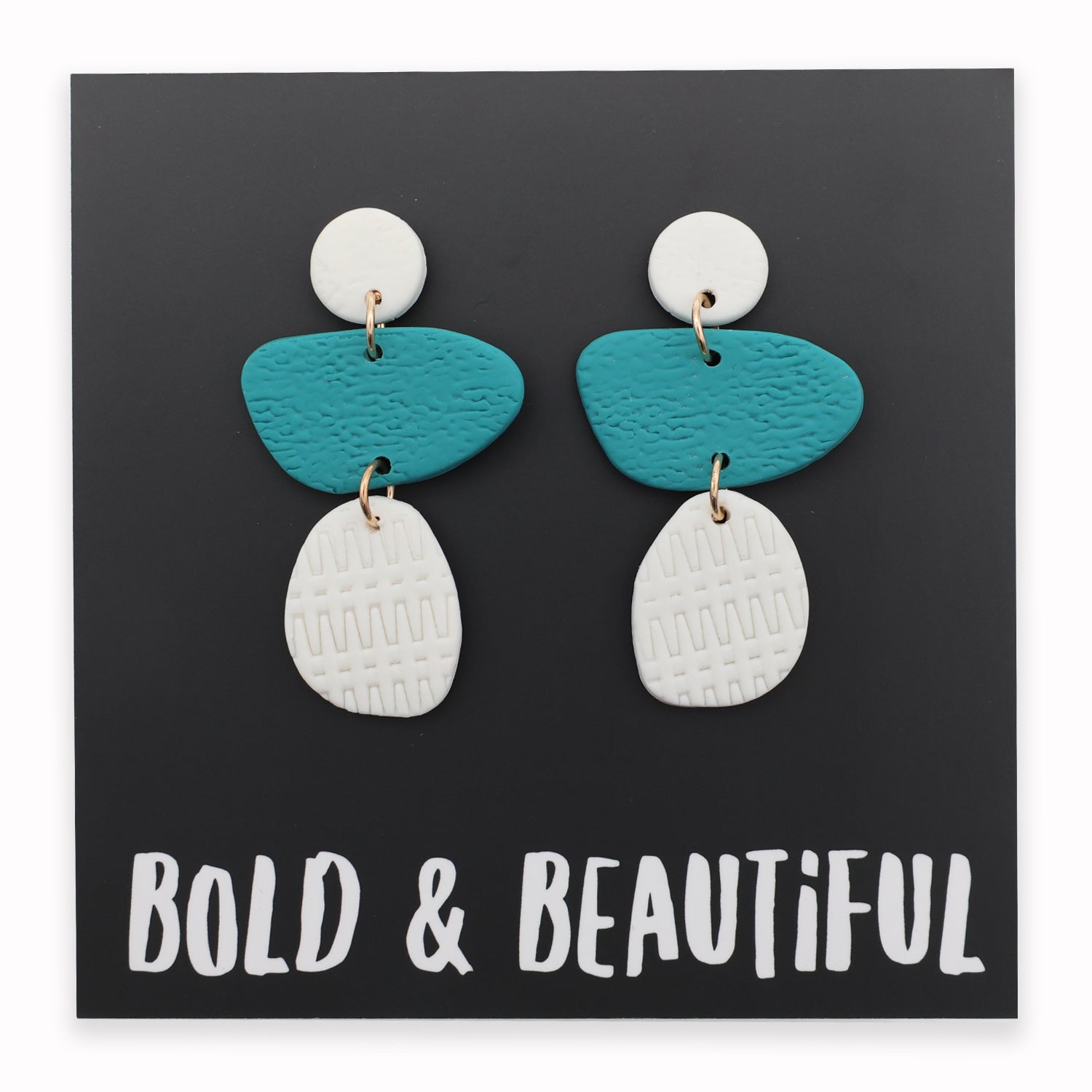 Pair of earrings with blue and white teardrop shapes on a black background with 'Bold & Beautiful' text.
