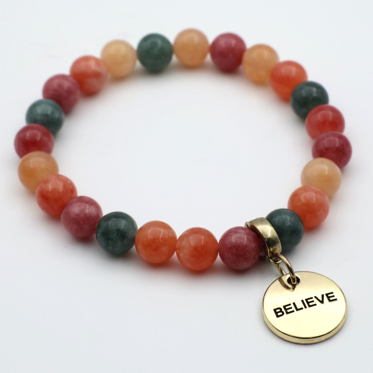 Multicolored beaded bracelet with a gold 'BELIEVE' charm on a white background