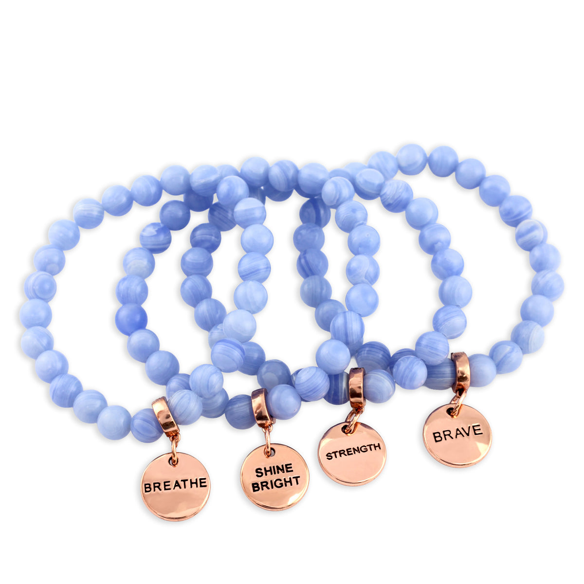 Set of blue beaded bracelets with rose gold charms on a white background