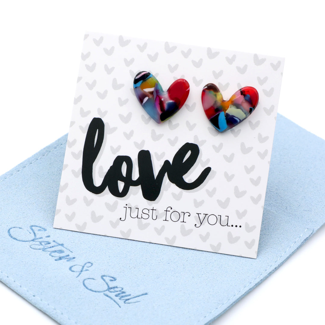 Heart-shaped earrings on a card with 'love just for you...' text on a blue pouch