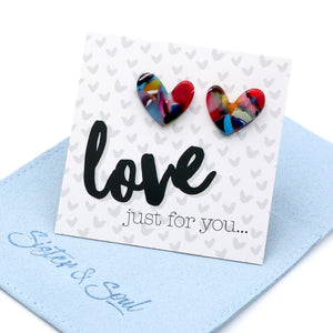 Heart-shaped earrings on a card with 'love just for you...' text on a blue pouch