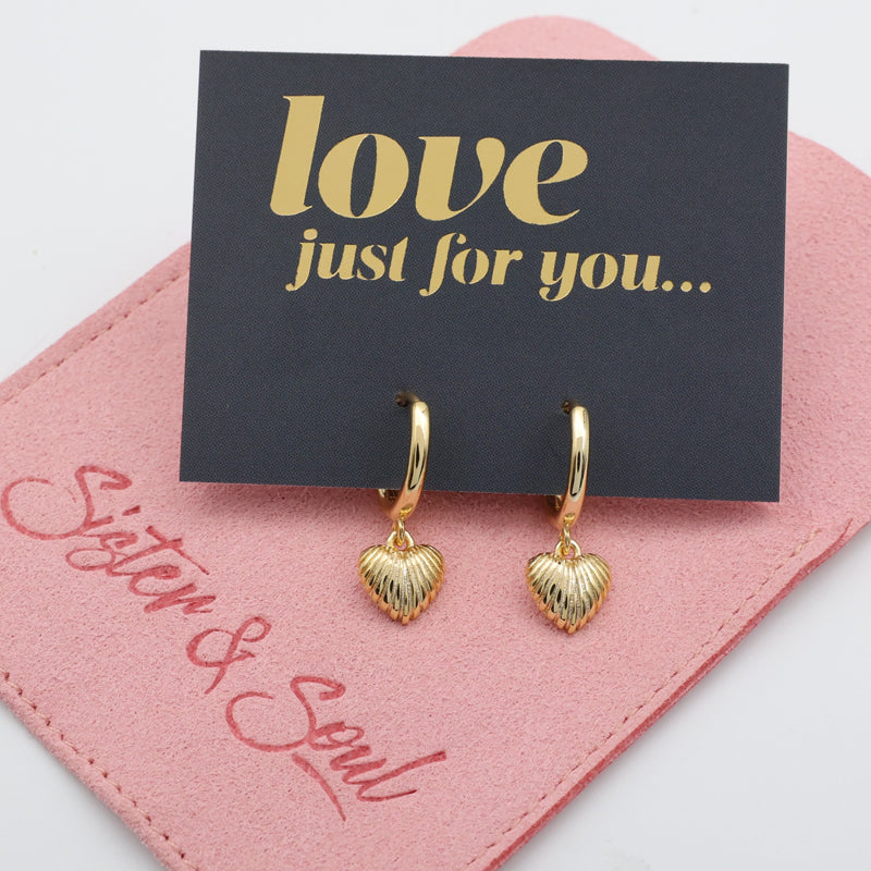 Gold heart-shaped earrings on a pink card with 'love just for you' text
