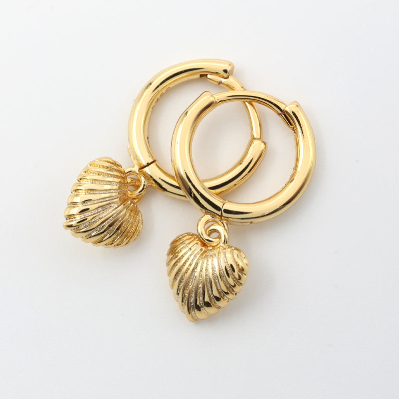 Gold hoop earrings with shell charms on a white background