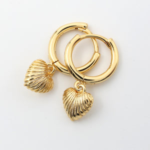 Gold hoop earrings with shell charms on a white background