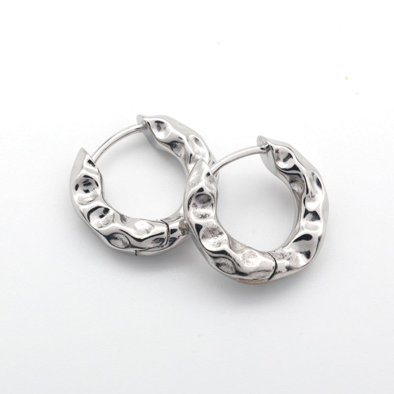  closed Silver Huggies hoop earrings on a white background