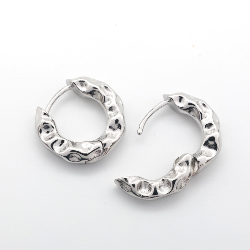 Open Silver Huggies hoop earrings on a white background