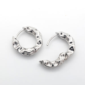 Open Silver Huggies hoop earrings on a white background