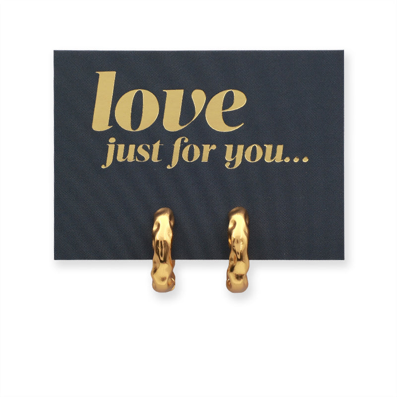 Gold hoop earrings on a love just for you card 