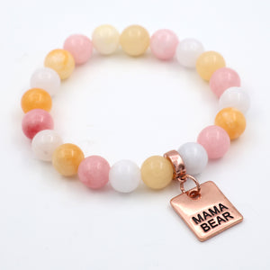 Beaded bracelet with 'Mama Bear' charm on a white background