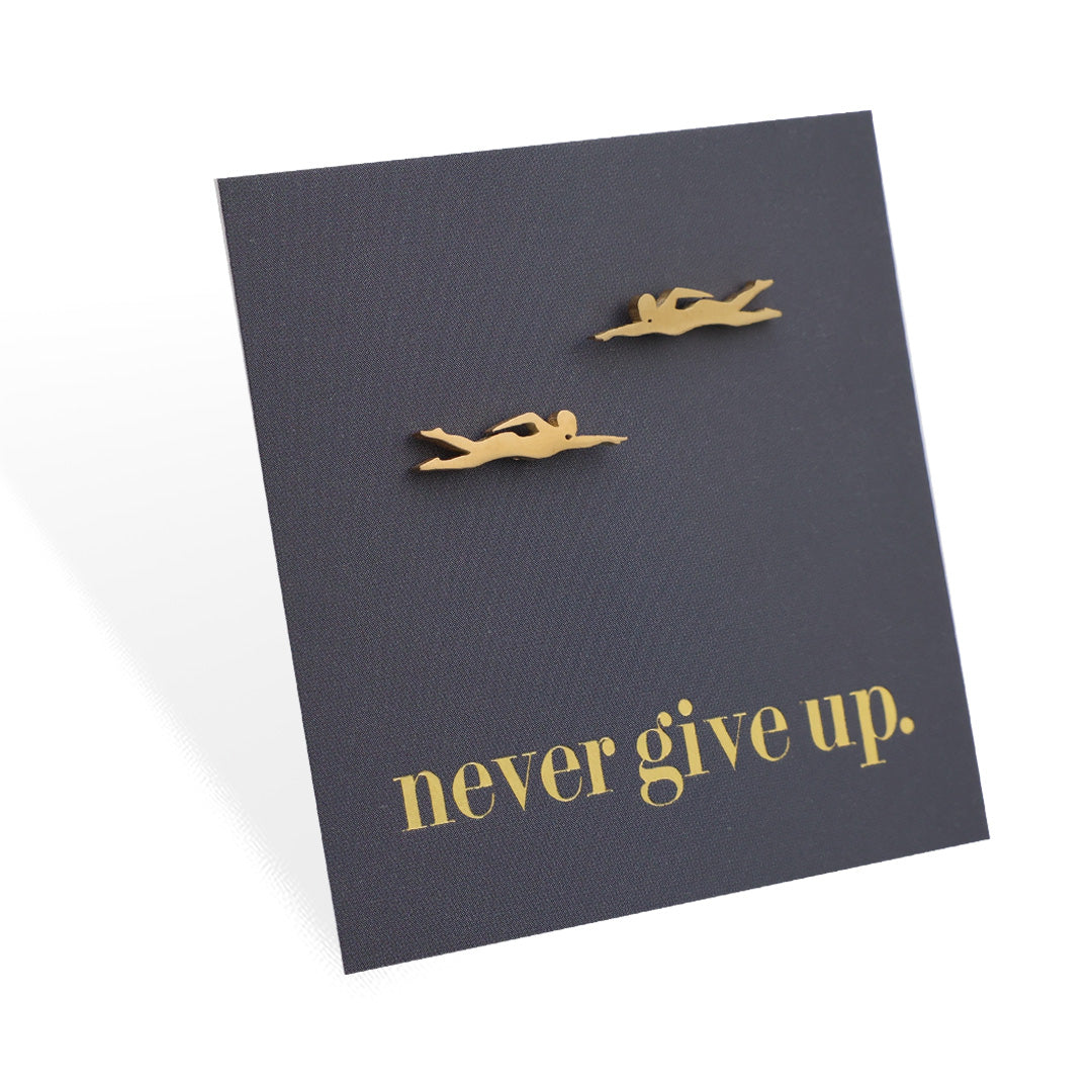 Four grey cards with motivational text 'never give up.' and small swimmer shaped figurines on a white background.
