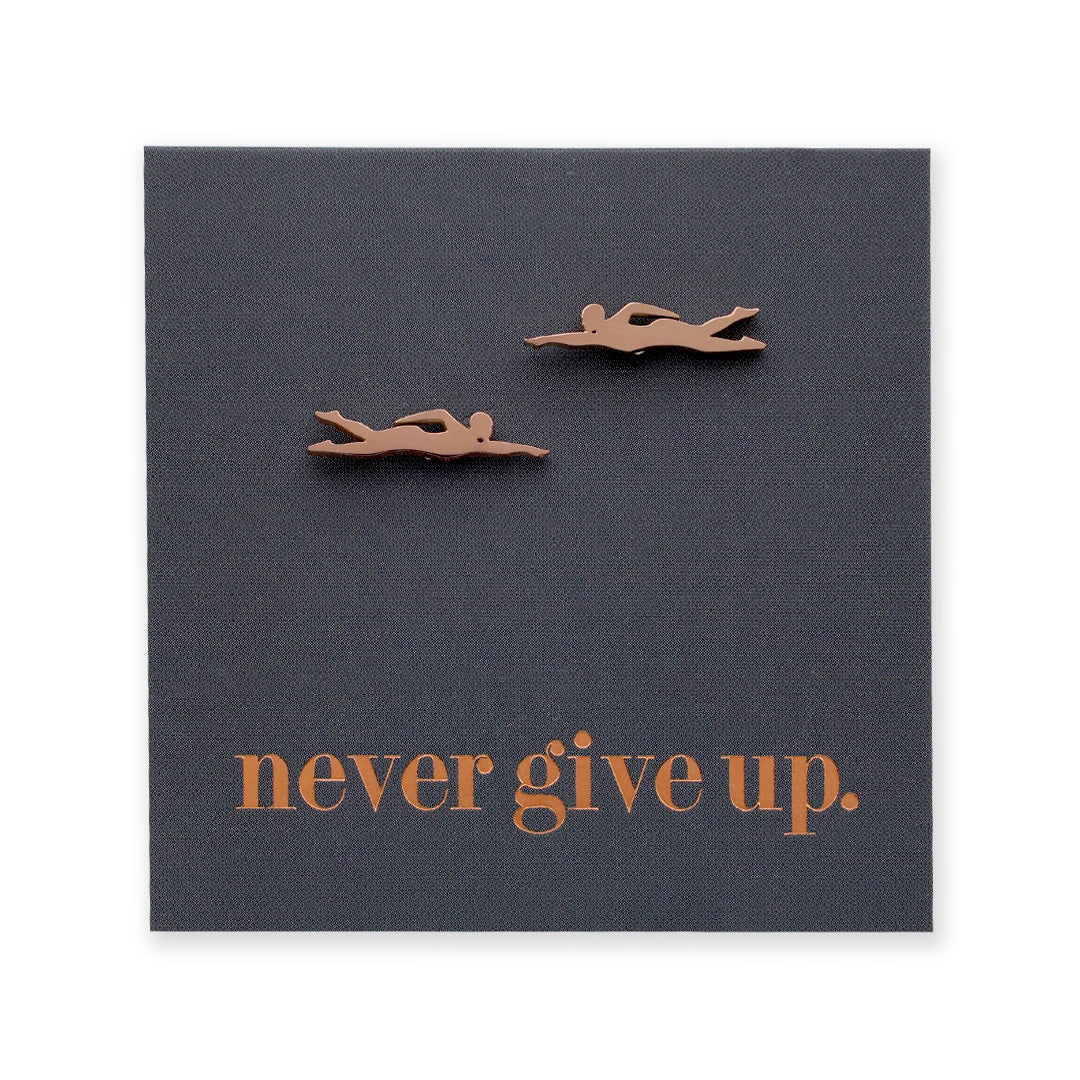 Motivational card with two swimmer figurines and 'never give up.' text on a dark blue background