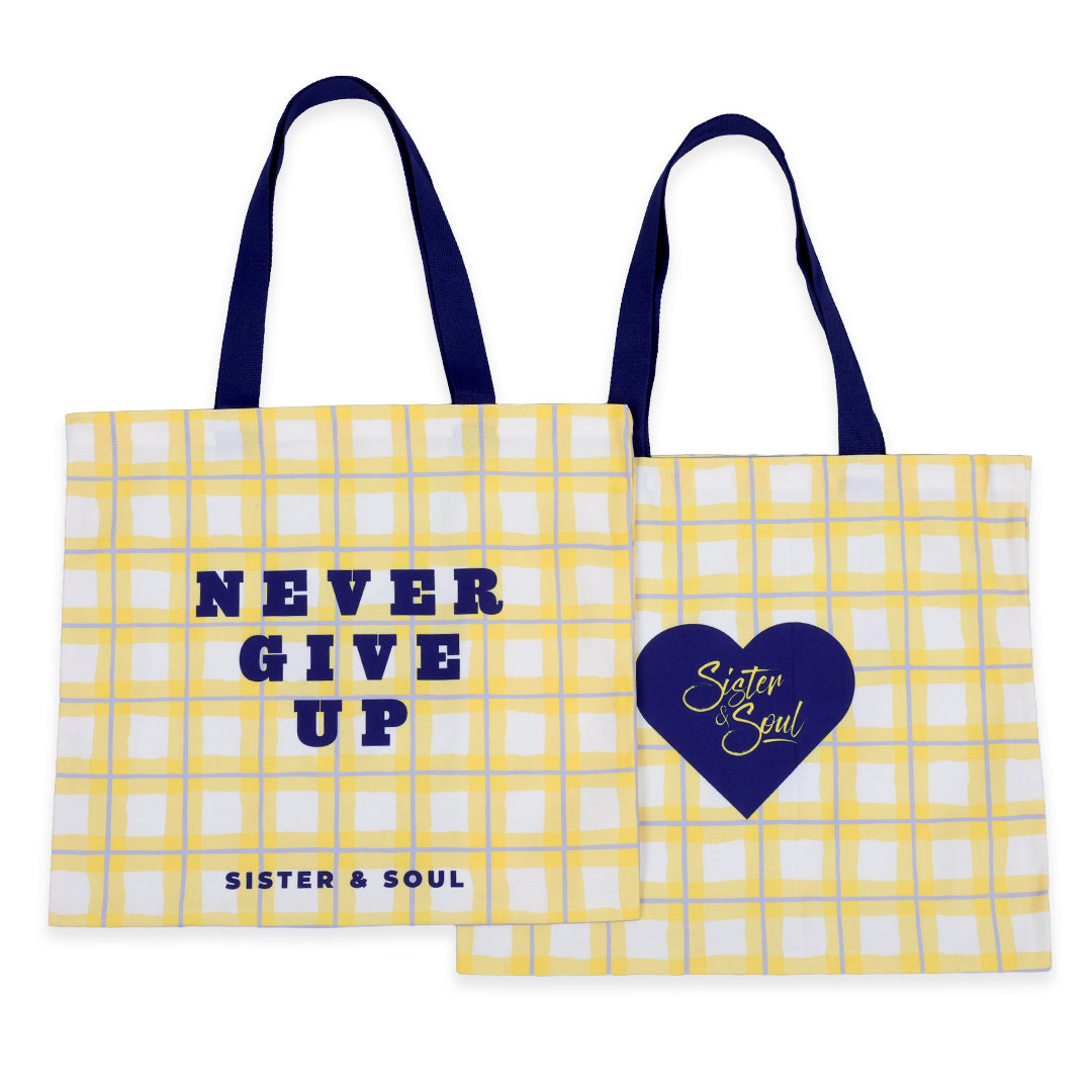 Two yellow tote bags with text and a heart design on a white background