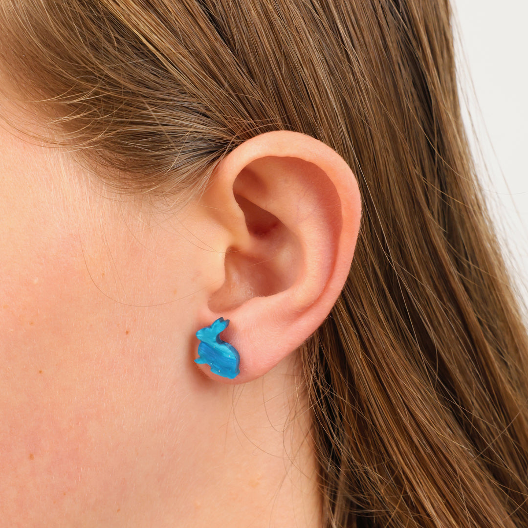teal aqua coloured rabbit earring studs in girls ear