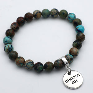 Bracelet with multicolored beads and a 'CHOOSE JOY' charm on a white background