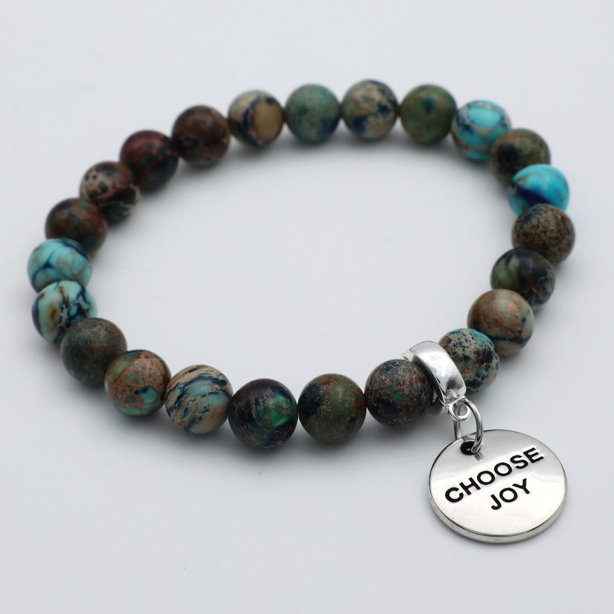Beaded bracelet with a 'CHOOSE JOY' charm on a light gray background