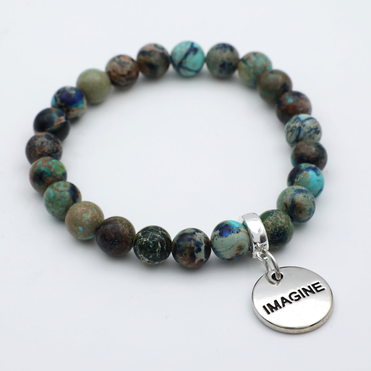 Beaded bracelet with 'IMAGINE' charm on a white background