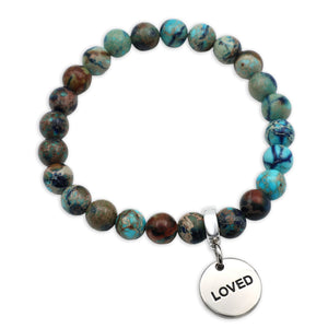 Beaded bracelet with 'LOVED' charm on a white background