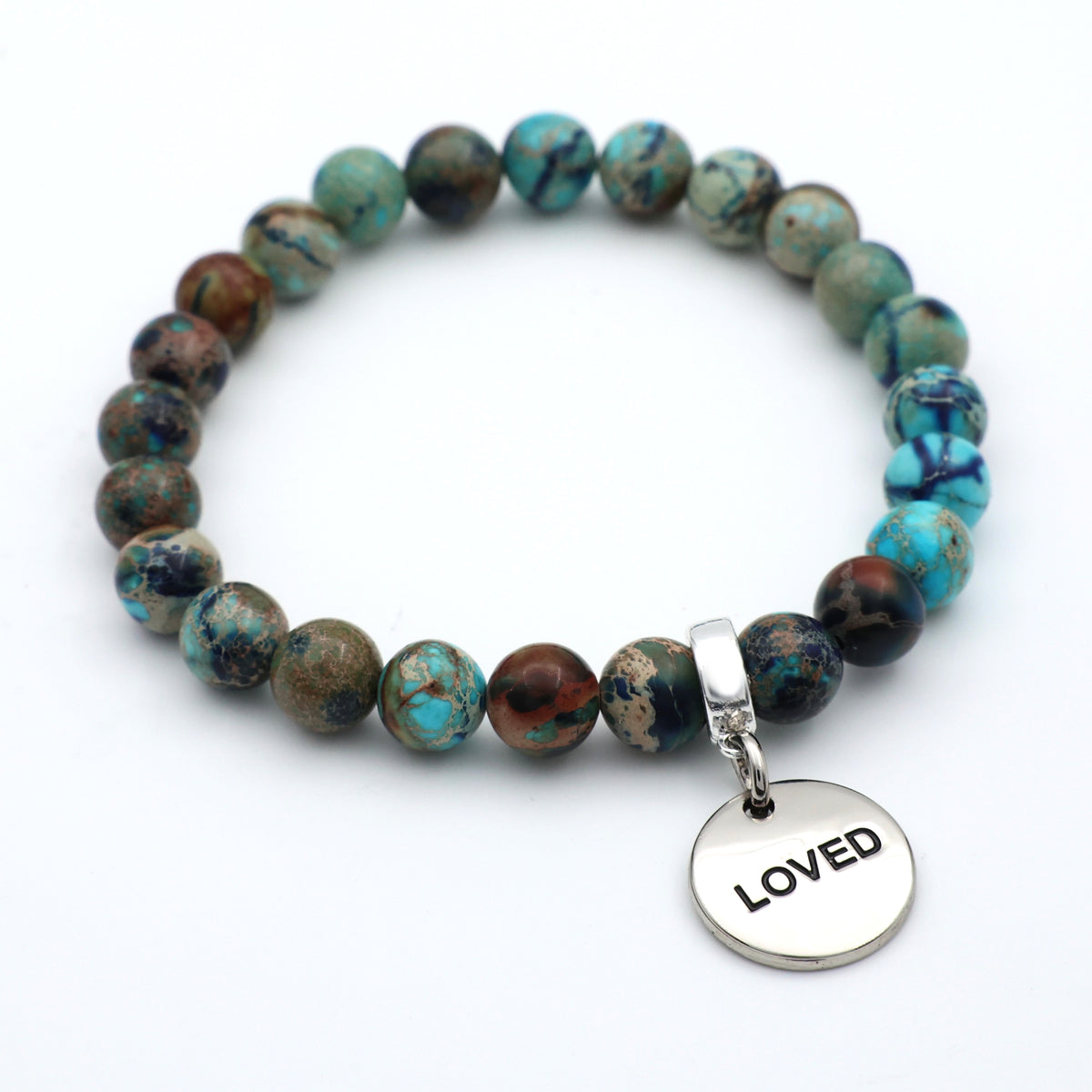 Beaded bracelet with a 'LOVED' charm on a white background