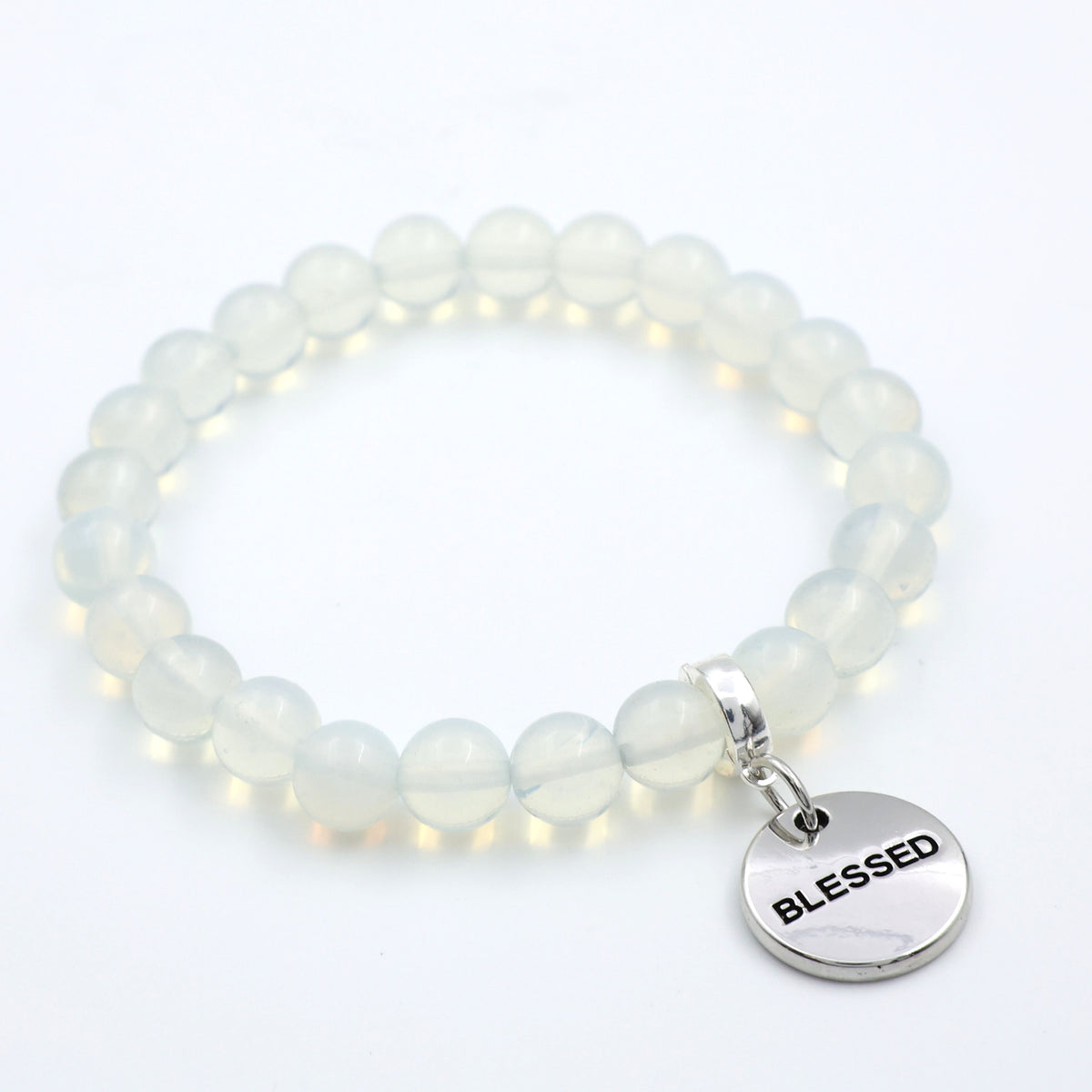White beaded bracelet with a 'BLESSED' charm on a white background