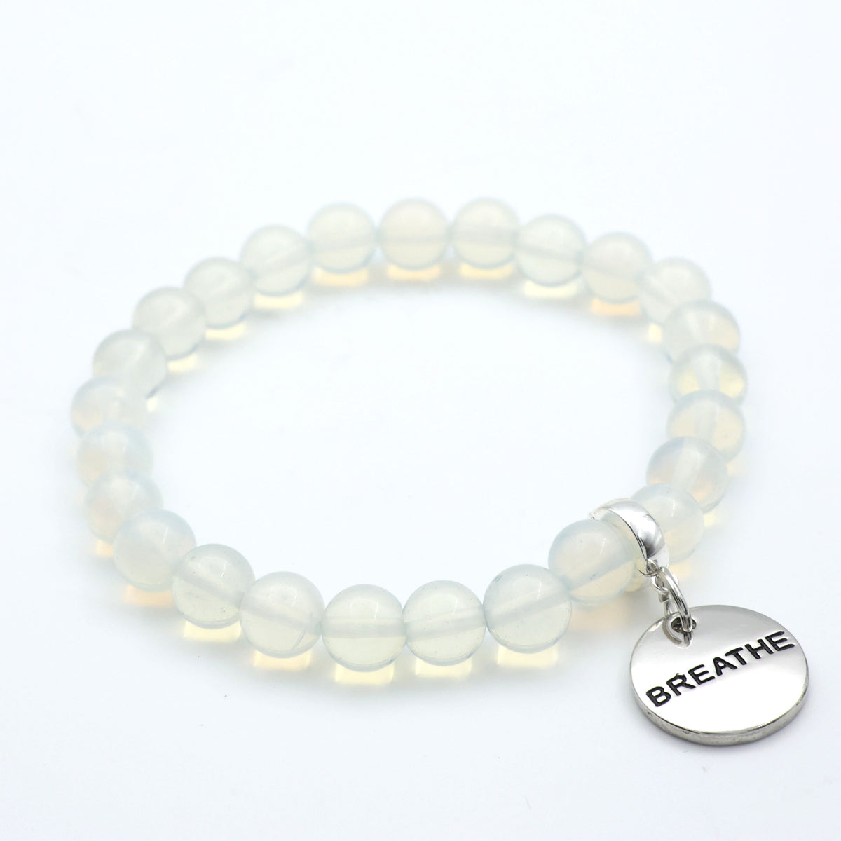 White beaded bracelet with a 'BREATHE' charm on a white background