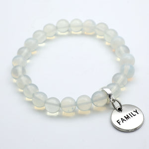 Beaded bracelet with a 'FAMILY' charm on a white background