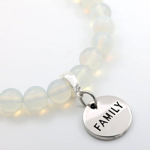 Bracelet with 'FAMILY' charm on a light background