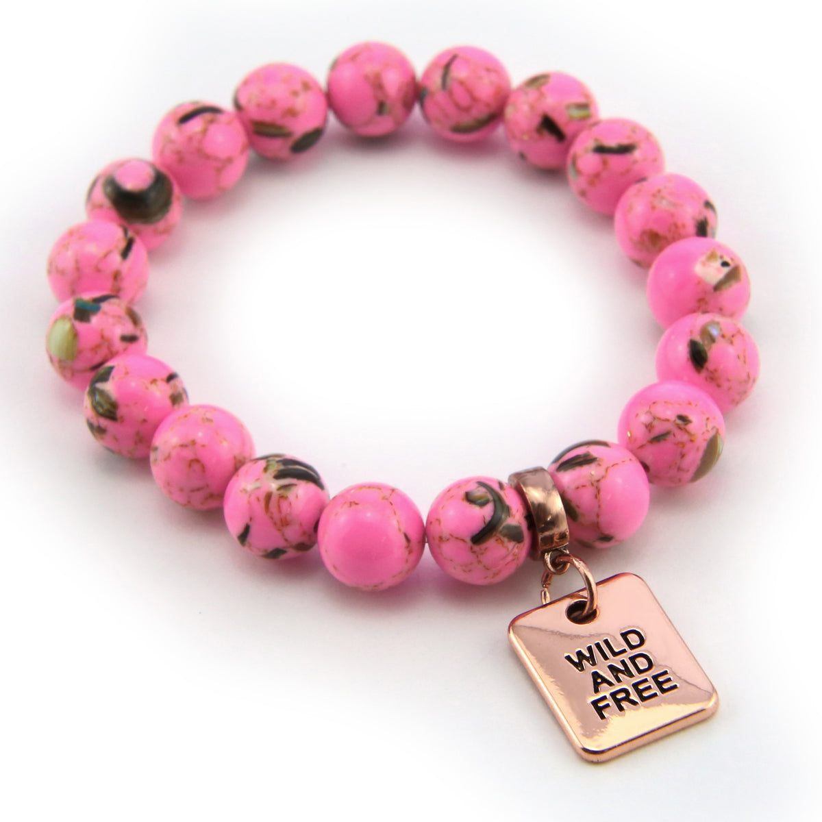 Pink beaded bracelet with a 'Wild and Free' tag charm on a white background