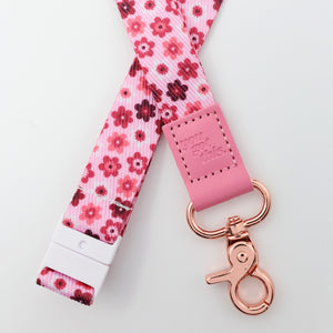 Floral patterned lanyard with pink clip and rose gold clasp on a white background