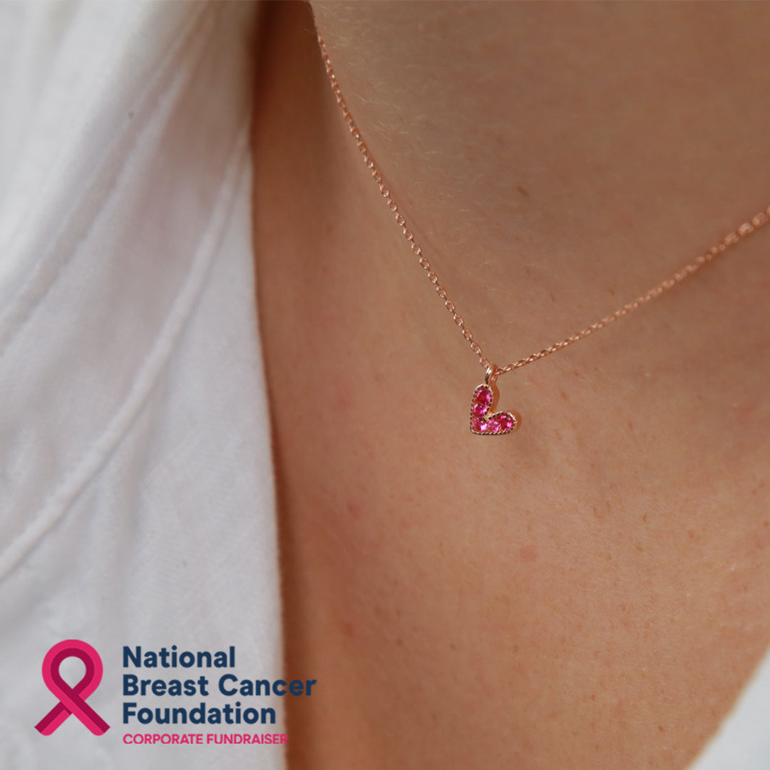 Pink heart pendant necklace sterling silver with 18K rose gold plating on gift card that has text that says so loved. 