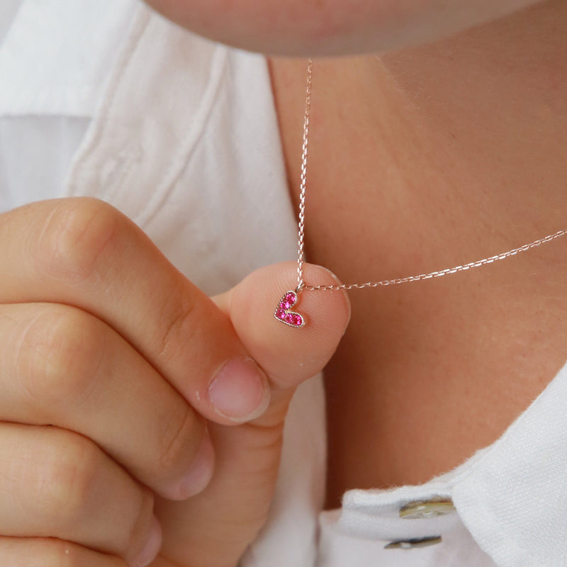 Pink heart pendant necklace sterling silver with 18K rose gold plating on gift card that has text that says so loved. 