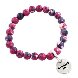 Bracelet with pink and purple beads and 'CHOOSE JOY' charm on a white background