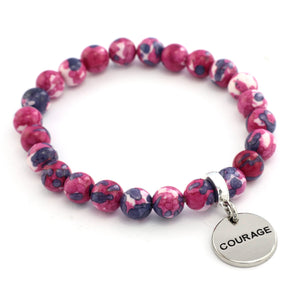 Pink and purple beaded bracelet with a 'COURAGE' charm on a white background