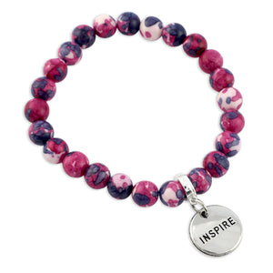 Beaded bracelet with 'INSPIRE' charm on a white background