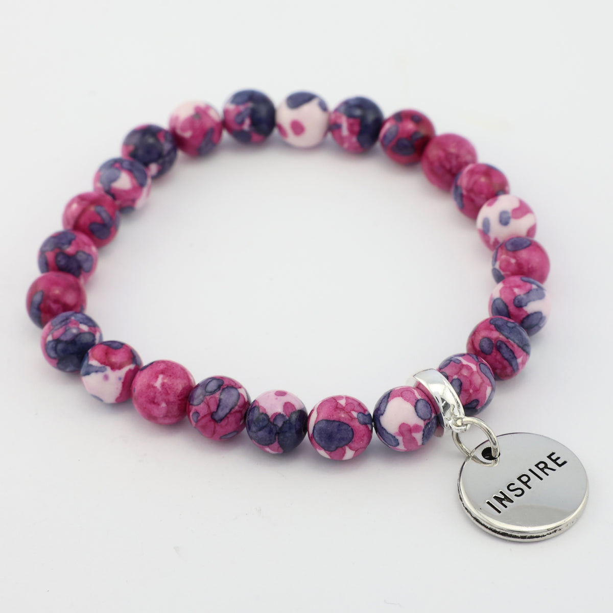 Pink and purple beaded bracelet with a silver 'INSPIRE' charm on a white background