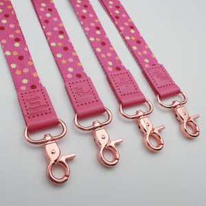 Pink Polka lanyards showing Be Kind, Teach Love Inspire, You Got This and So Loved embossed trims and lobster clasps.