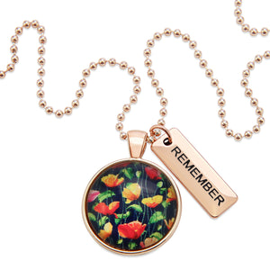 Necklace with floral pendant and 'REMEMBER' tag on a white background
