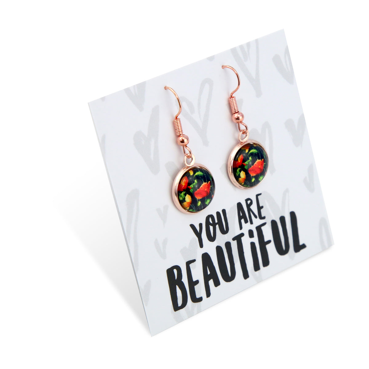 Rose gold earrings with floral design on a card that says 'You are Beautiful' on a white background