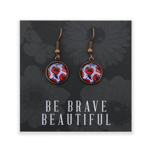 Pair of earrings with floral design on a card with 'Be Brave Beautiful' text