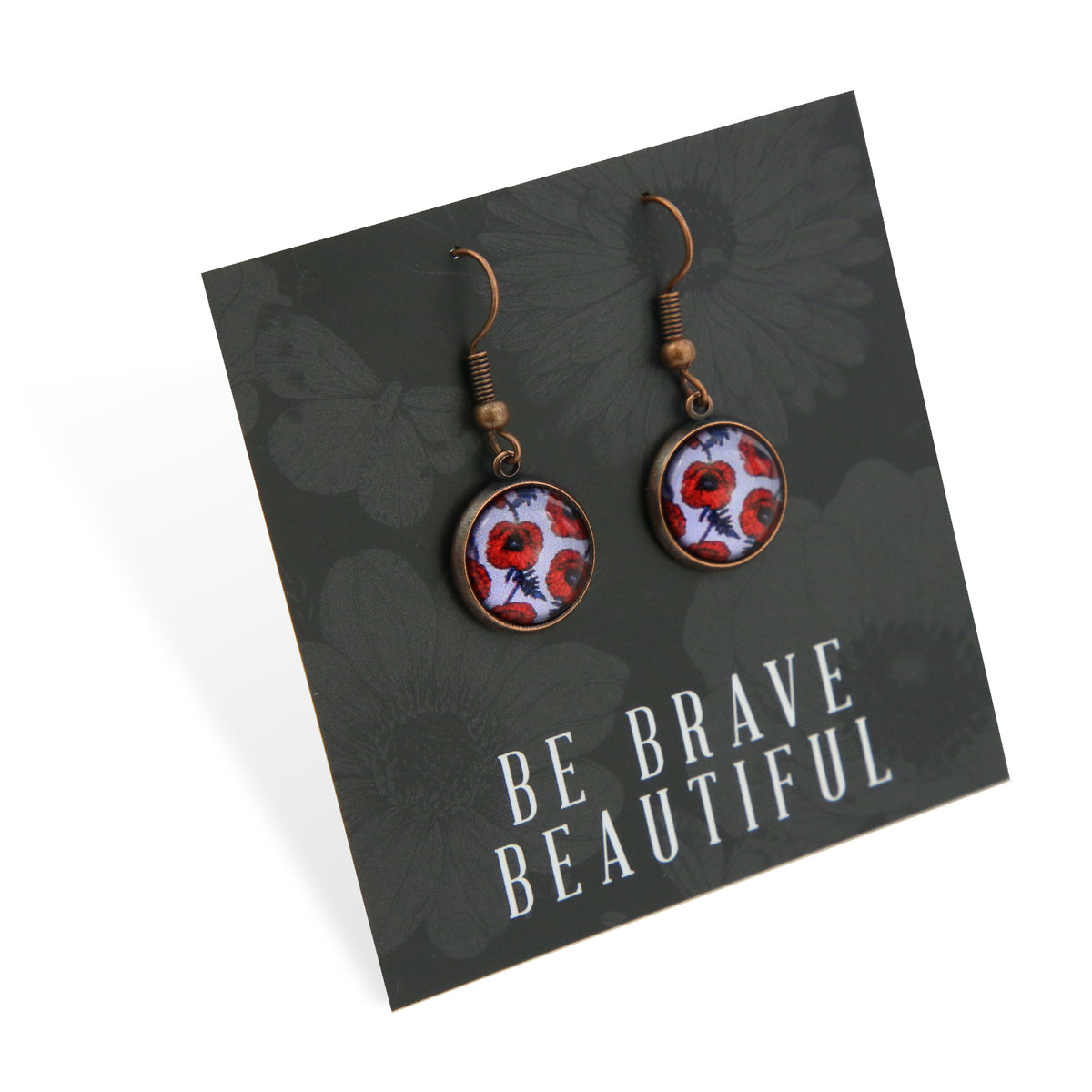 Pair of earrings with floral design on a card with 'Be Brave Beautiful' text