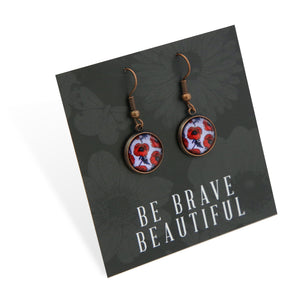 Pair of earrings with floral design on a card with 'Be Brave Beautiful' text