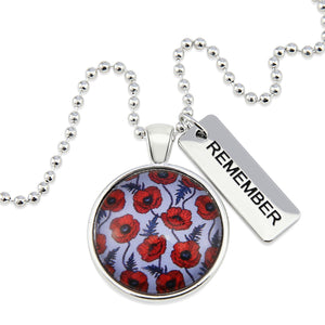 Necklace with floral pendant and 'REMEMBER' tag on a white background