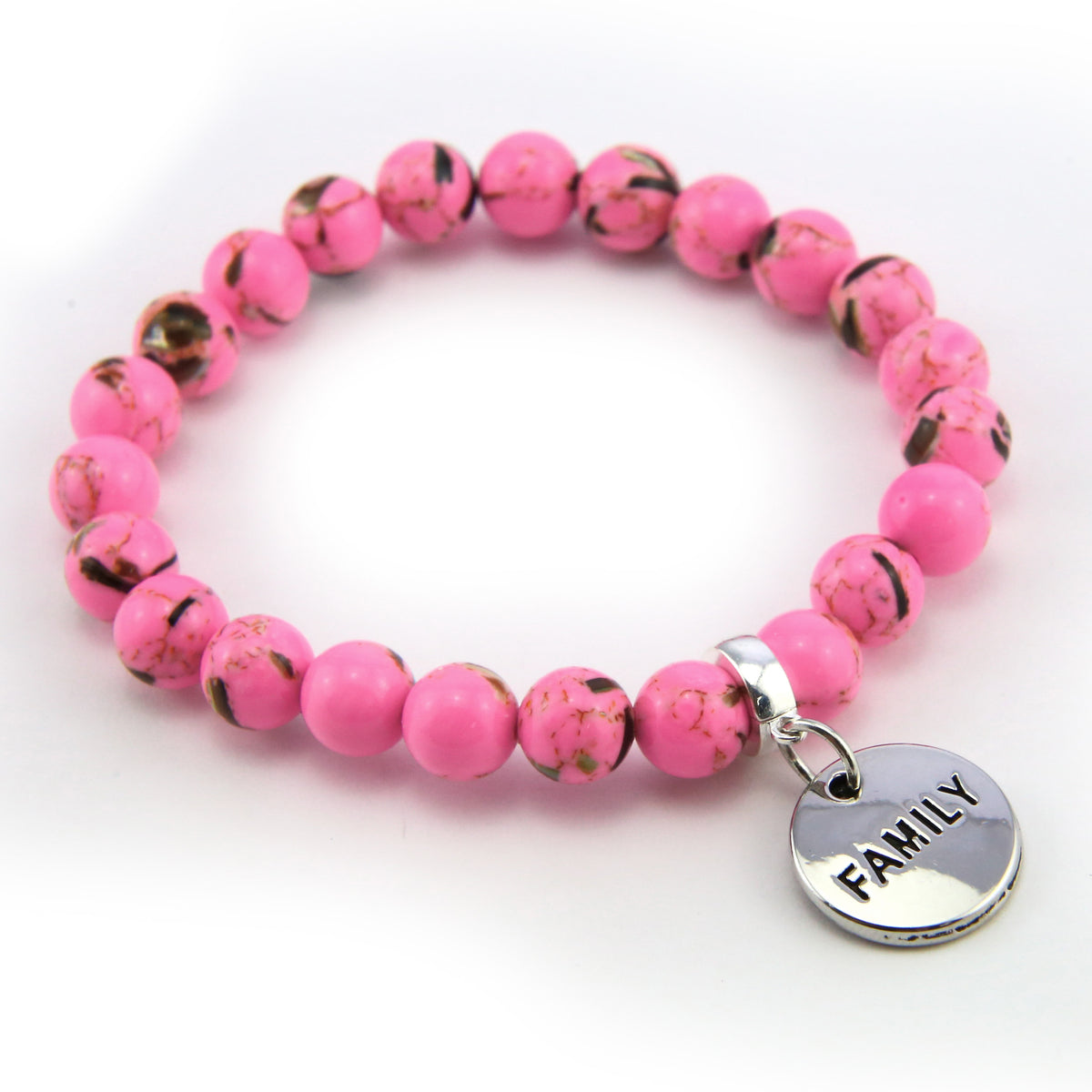 Pink beaded bracelet with a silver 'FAMILY' charm on a white background