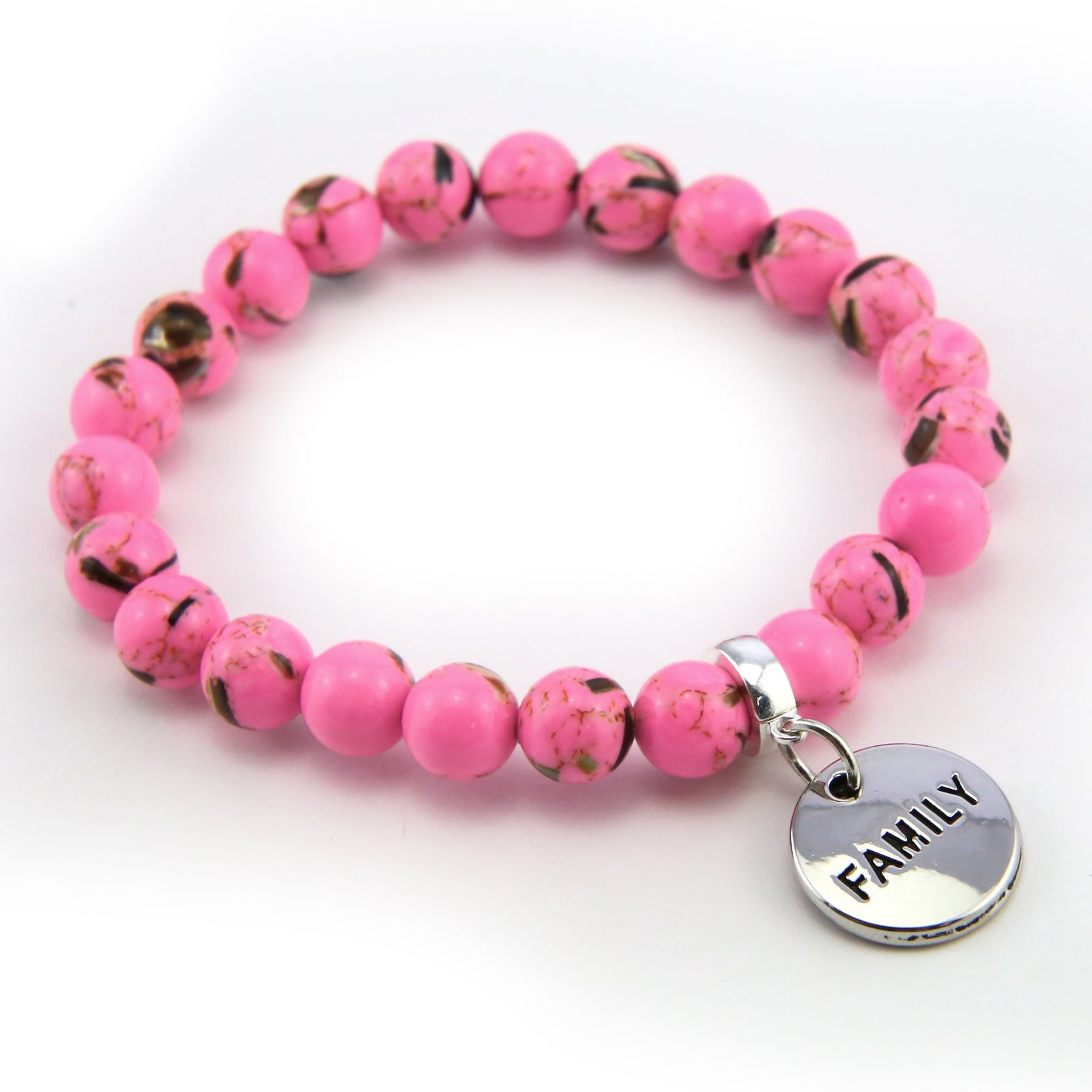 Pink beaded bracelet with silver charms on a white background