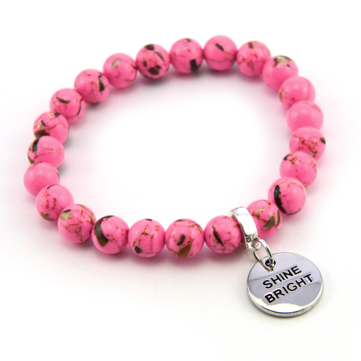 Pink beaded bracelet with a 'Shine Bright' charm on a white background
