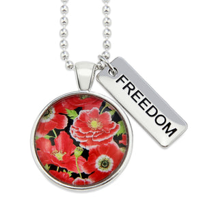 Necklace with floral pendant and 'FREEDOM' tag on a white background