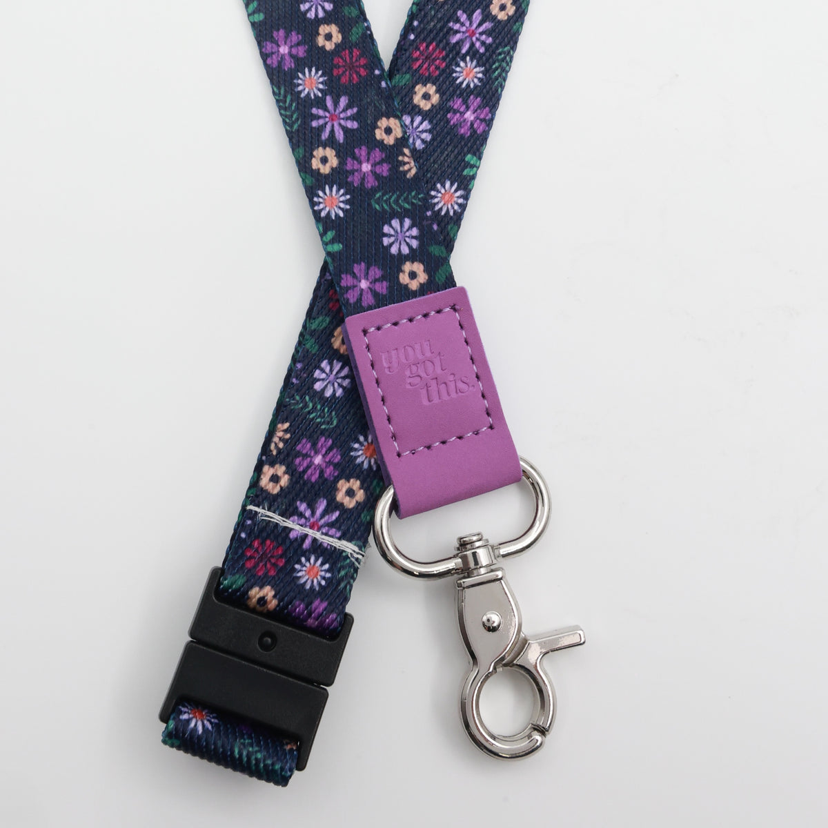 You Got This embossed on a navy floral lanyard with purple trim and a lobster clasp.
