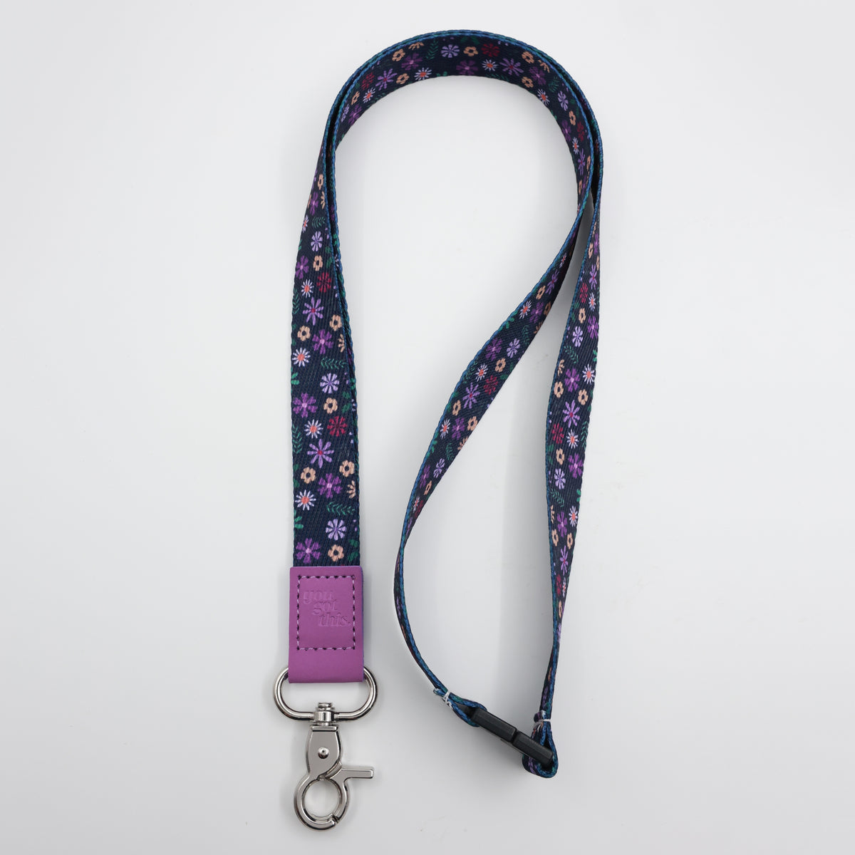 You Got This embossed on a navy floral lanyard with purple trim and a lobster clasp.